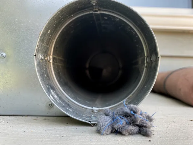 Wallingford Center Dryer Vent Cleaning technician using specialized equipment to clear severe dryer vent blockage in Wallingford Center